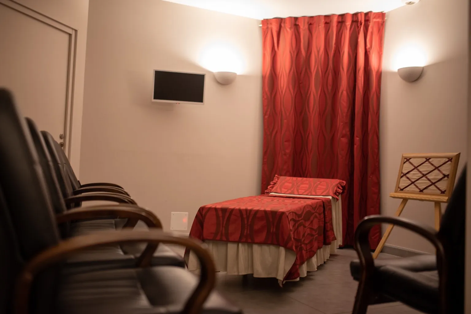 Chambre funéraire aménagée avec lit de présentation et draperies rouges